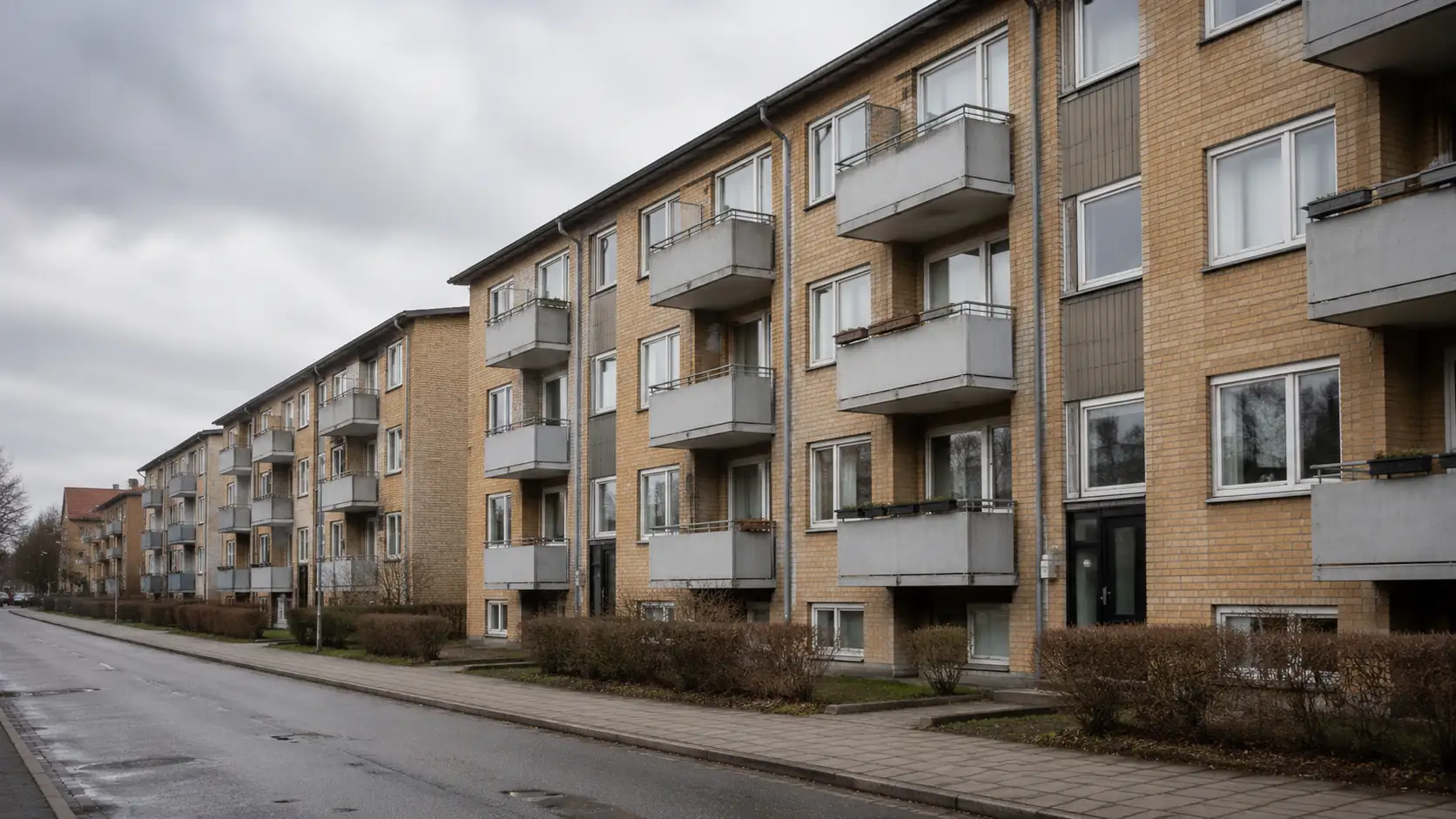 Older apartment with balcony located next to a small road